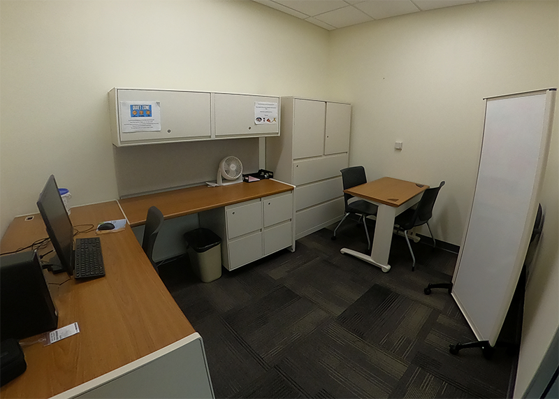 office with computer, desks, and two chairs